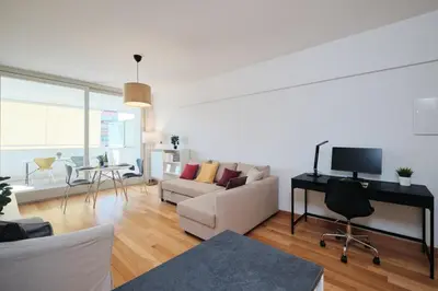 a living room with a white couch and a tv at Trastevere-Colosseo, Elegant Apartment Wi-Fi & A-C in Rome