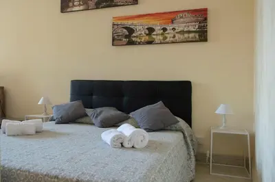 a bedroom with a bed and a chair in it at Spanish Steps Studio in Rome