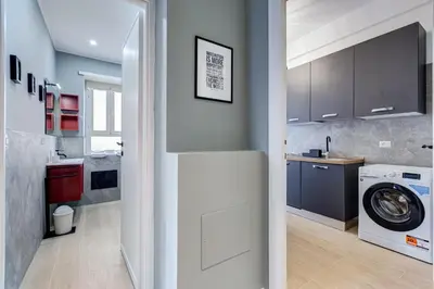 a kitchen with a washer and a washing machine at Domus Suite Gemelli - Relax & Comfort in Rome