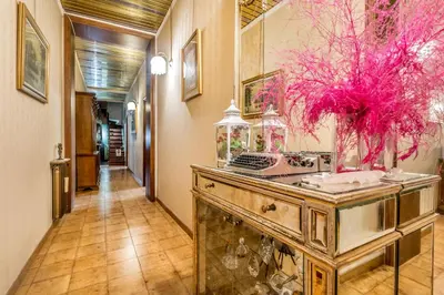 a hallway with a table with a fish tank at Dimora Armanda Roma in Rome