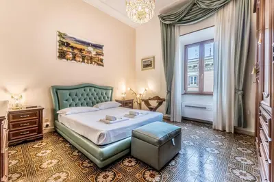 a bedroom with a green bed and a window at Dimora Armanda Roma in Rome