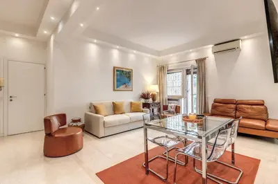 a living room with a glass table and a couch at Maison Sofia in Rome
