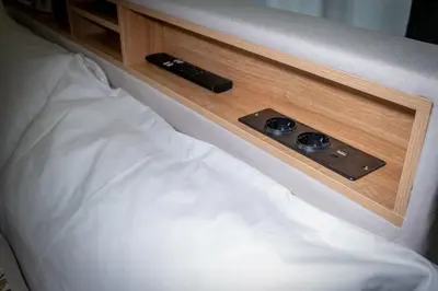 a bed with two remote controls on top of it at The Suitest Roma Apartment Appio Latino in Rome