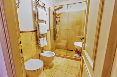a bathroom with a toilet and a sink and a shower at Casa Arpinelli in Rome