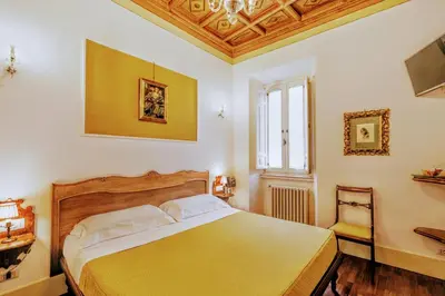 a bedroom with a large bed and a window at Casa Arpinelli in Rome