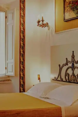 a bedroom with a bed with a cross on the wall at Casa Arpinelli in Rome