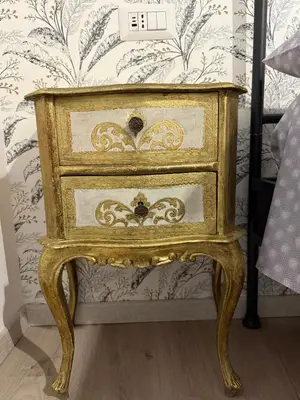 a nightstand with a drawer in a bedroom at Apartment Aurum Colosseum in Rome