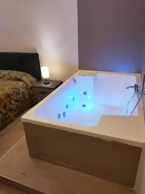 a large bath tub in a room with a bed at Igg VATICAN HOLIDAY in Rome