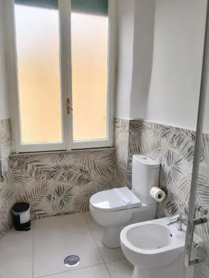 a bathroom with a toilet and a sink at Nexus Prati Suite in Rome
