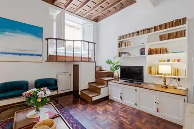 a living room with a television and a staircase at Rome as you feel - Vetrina Terrace in Rome