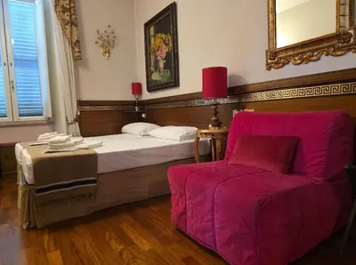 a bedroom with a large bed and a couch at Chez Oriana Termini St in Rome