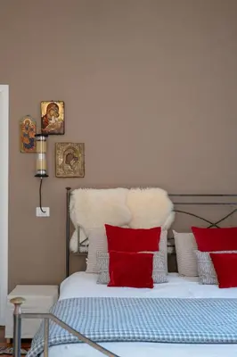 a bedroom with a bed with red and white pillows at Emanuela Home - VATICAN in Rome