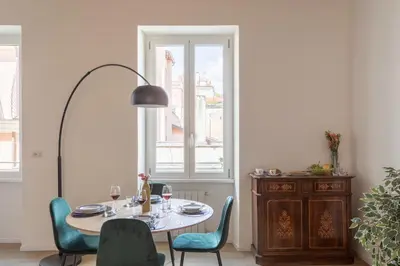 a dining room with a table and chairs and a window at iFlat Peaceful & Charming Hideaway near Vatican in Rome