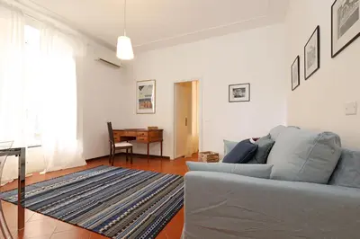a living room with a blue couch and a table at 23 FREE ROME Trastevere in Rome