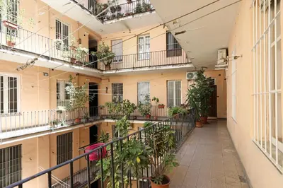 an internal courtyard of a building with plants at 23 FREE ROME Trastevere in Rome