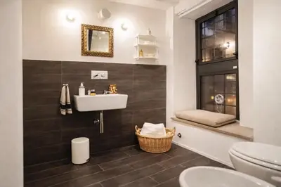 a bathroom with a sink and a toilet at Modern Flat Historic 1200s Palace Steps from Navona in Rome