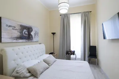 a bedroom with a white bed and a window at Town House 57 in Rome
