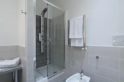 a bathroom with a shower and a toilet and a sink at Town House 57 in Rome