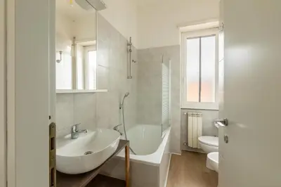 a bathroom with a sink and a tub and a toilet at LA PETITE MAISON a ROME in Rome