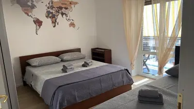a bedroom with a bed with a world map on the wall at LA PETITE MAISON a ROME in Rome