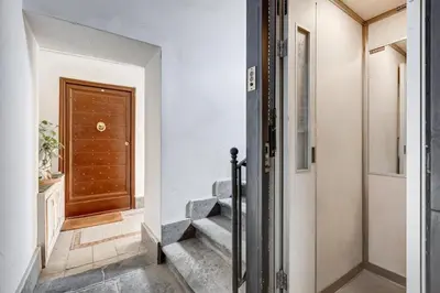 a hallway with stairs leading to a door at Mazza Stay in Rome