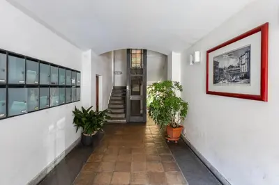 a hallway with potted plants in a building at Mazza Stay in Rome