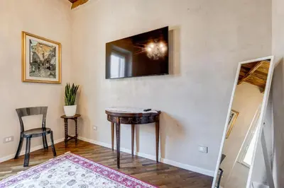 a room with a table and a television on the wall at Mazza Stay in Rome