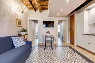 a living room with a blue couch and a table at Mazza Stay in Rome