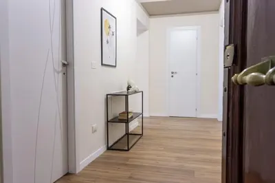 a hallway with white walls and a wooden floor at Rome Bliss GuestHouse in Rome