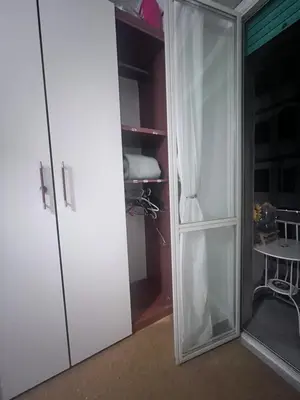 a white closet with a glass door in a room at Na Notte a Roma in Rome