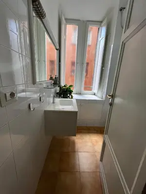 a bathroom with a sink and a window at Casa Luciano in Rome