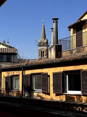 an old building with shuttered windows and a tower at Pace Blu Roma in Rome