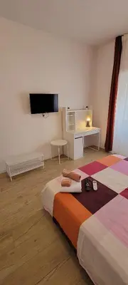 a bedroom with a bed and a flat screen tv at Trinita' dei Monti, night check-in also available in Rome