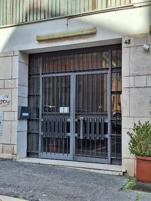a store front with glass doors on a building at Fontana di Trevi Apartment, 24h check-in in Rome