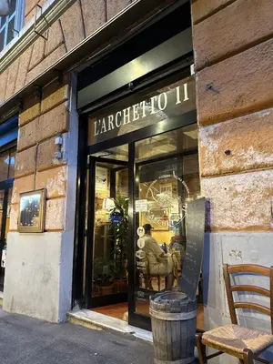 a store window with a sign that reads harper toil at Dormire in Trastevere in Rome