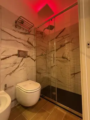 a bathroom with a toilet and a glass shower at Dormire in Trastevere in Rome
