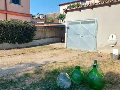 three green vases sitting in front of a garage at La Casa dei Melograni in Rome