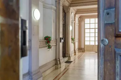 a hallway in a building with flowers on the wall at Porta Pia Stay GuestHouse in Rome
