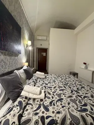 a bedroom with a large bed with two towels on it at Suncity Sweet Home in Rome