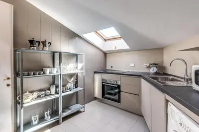 a kitchen with a sink and a stove at Frangipane Colosseum Apartments in Rome