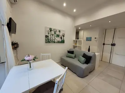 a living room with a white table and a couch at Castro Pretorio Sweet Home in Rome