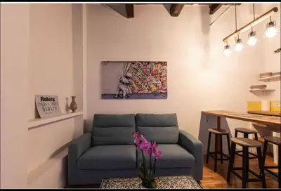 a living room with a couch and a table at Home trastevere in Rome