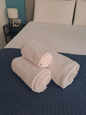 a pair of towels sitting on top of a bed at At Home Gaeta Guest House in Rome