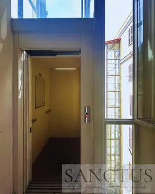 a hallway of a building with a door and a window at Sanctus Michael Archangelus in Rome