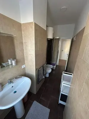 a bathroom with three toilets and a sink at Casa Susanna in Rome