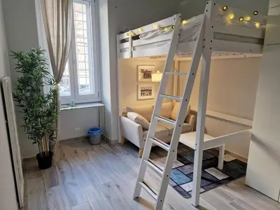 a bunk bed in a room with a ladder at Graziosa camera in posizione strategia con bagno privato esterno in Rome