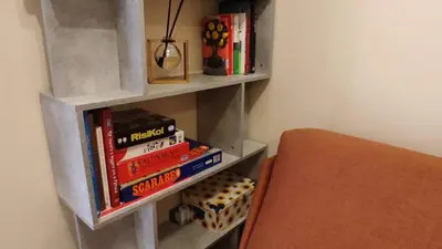 a book shelf with books on it next to a bed at Trilocale indipendente vicino Metro per Colosseo - Domus in Rome in Rome