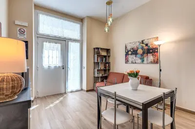a dining room and living room with a table and chairs at Trilocale indipendente vicino Metro per Colosseo - Domus in Rome in Rome