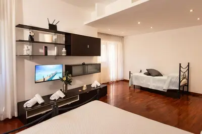 a bedroom with a bed and a tv on a wall at Residenza in Vaticano Roma in Rome