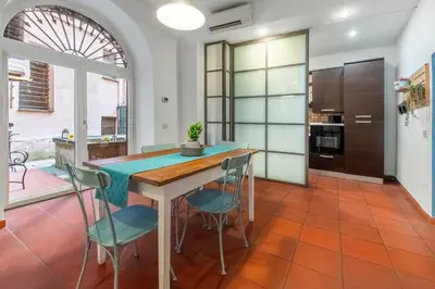 a kitchen with a wooden table and chairs at Number Five Apartment in Trastevere in Rome